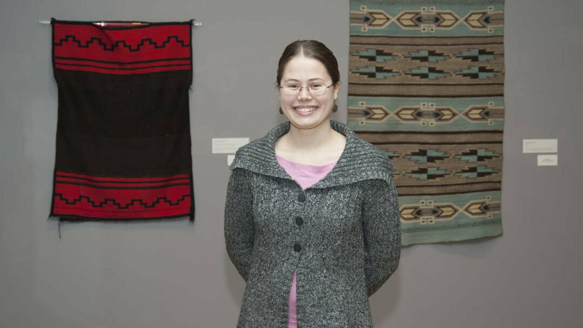 Kasey Kendall, an ND student who participated in Prof. Joanne Mack's 2011 class that curated an exhibition. She stands next to the display of Native American objects that she selected, researched and described in exhibition text panels and labels