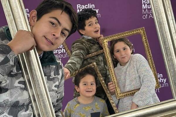 Image of kids holding frames and looking thorugh them at viewer.